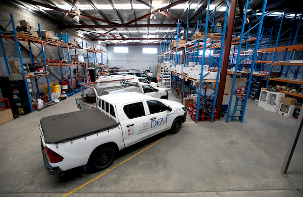 Company cars inside a warehouse